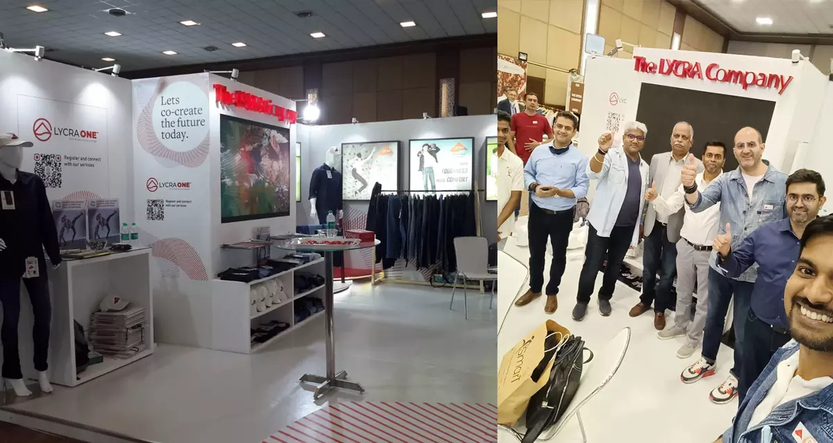 The LYCRA Company employees and booth visitors give a thumbs up at the 2022 India DenimandJeans Show for denim innovations.