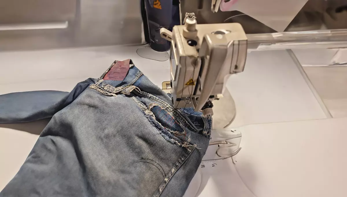 A pair of jeans being sewn 