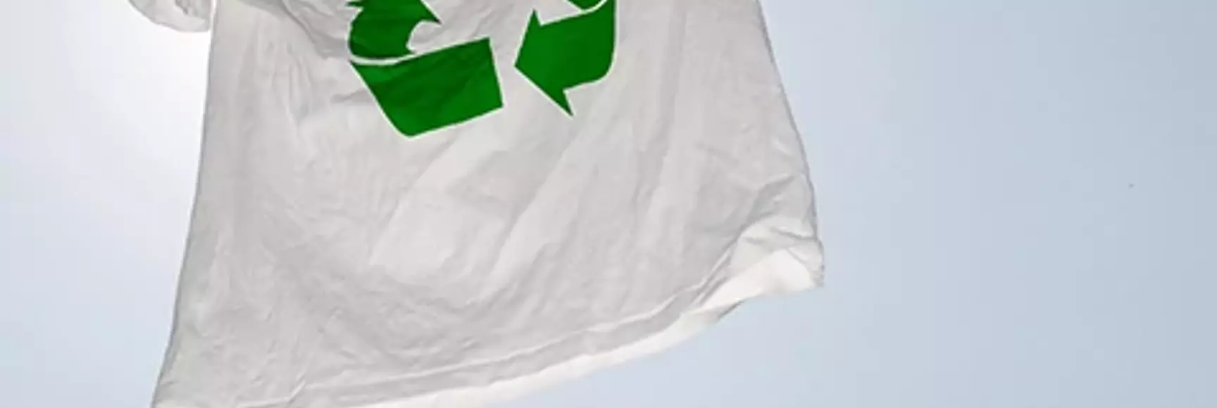 A white t-shirt on a clothesline with recycling logo represents the promise of apparel chemical recycling touted by experts