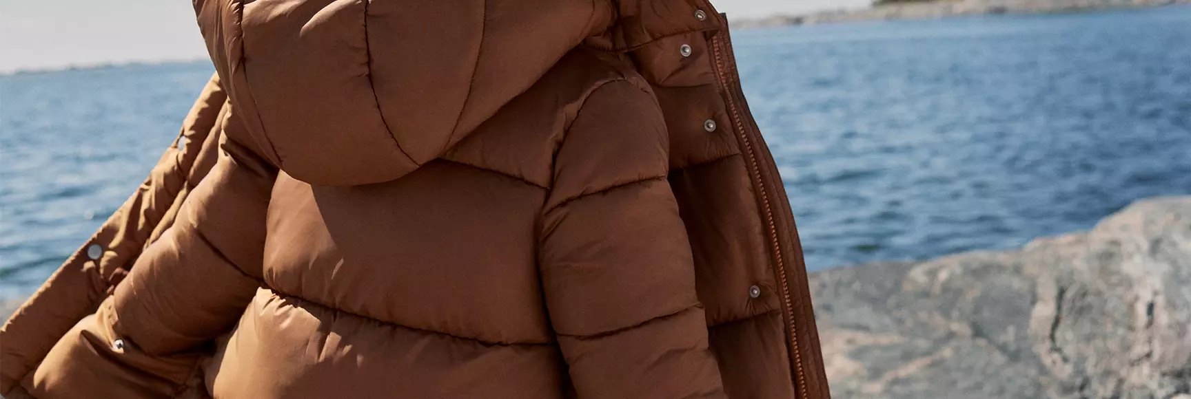 A child models a puffer coat from H&M Kids featuring sustainable insulation made with THERMOLITE® EcoMade technology.