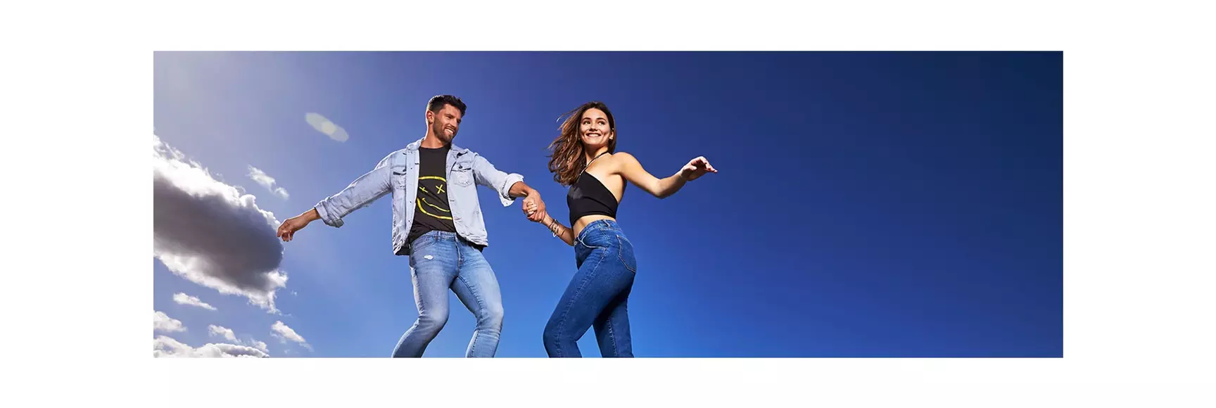 A couple model performance stretch denim jeans powered by LYCRA® brand spandex fiber solutions for lasting comfort and fit.