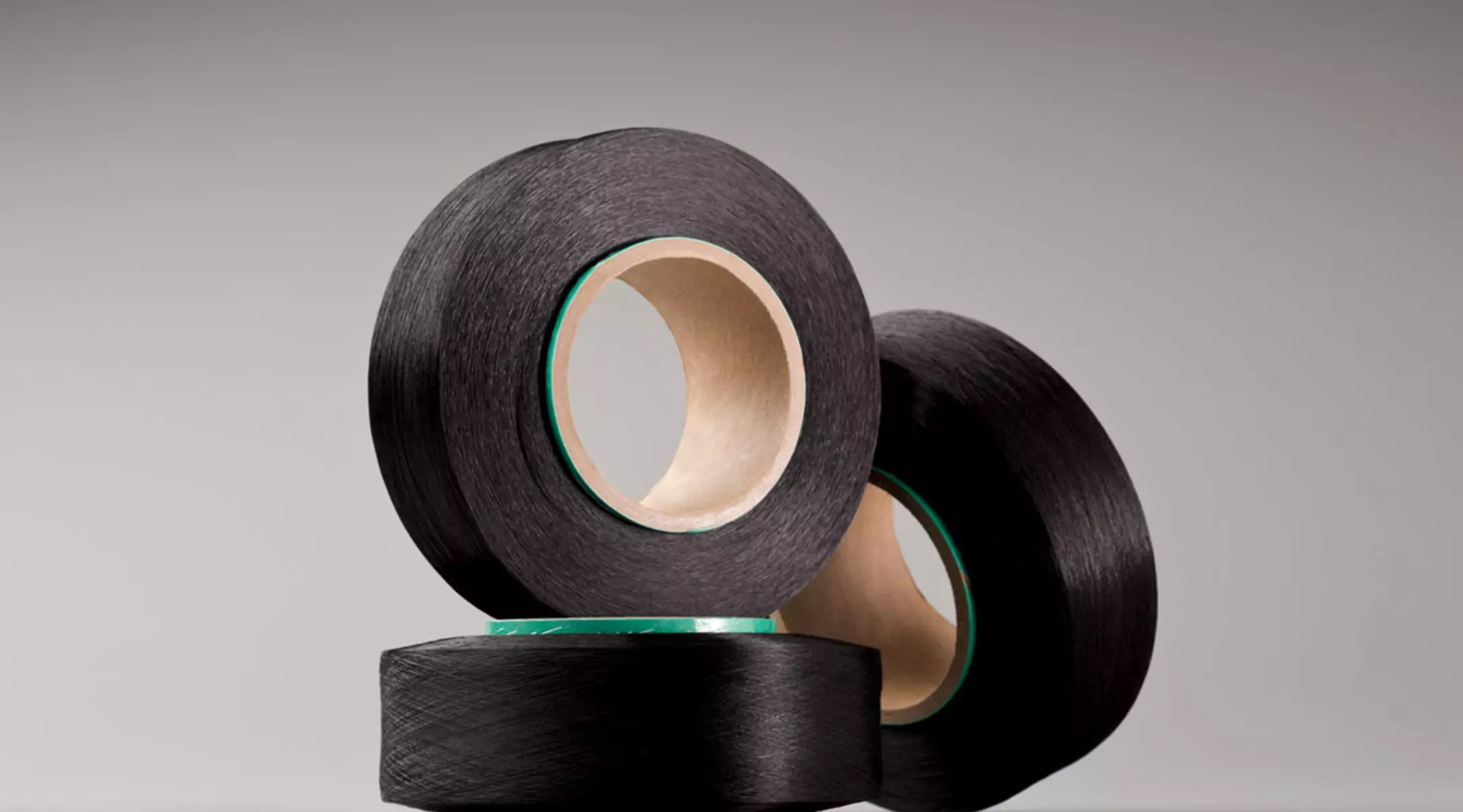 Contemporary bobbins of LYCRA® fiber, which is combined with other fibers to create fabric used to make clothing