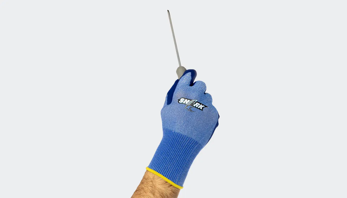 A hand in a cut-resistant glove holds up a screwdriver.